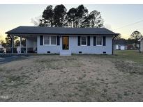 Charming single-story home with a covered carport and inviting entrance at 109 Pine St, Dunn, NC 28334