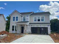 Two-story home with gray siding, black roof, and visible construction materials at 1248 Randwick Valley Ct, Zebulon, NC 27597