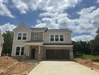 Two-story home featuring mixed brick and siding, attached garage, and a concrete driveway at 1248 Randwick Valley Ct, Zebulon, NC 27597