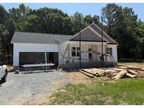 An exterior view of a home under construction with white siding and a grey shingled roof at 13159 S Nc-231 Hwy, Middlesex, NC 27557