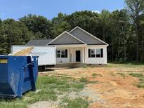 Charming new construction with white siding, black shutters, and a wooded backdrop at 13159 S Nc-231 Hwy, Middlesex, NC 27557