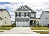 Charming two-story home with a gray exterior, white trim, and a two-car garage at 1740 Golden Honey Dr, Wake Forest, NC 27587
