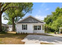 Charming single-story home featuring a welcoming porch and a new driveway at 208 W Holt St, Burlington, NC 27217