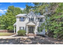 Charming two-story home with classic architectural details, manicured landscaping, and a welcoming front porch at 24 W Canterbury Ct, Wendell, NC 27591