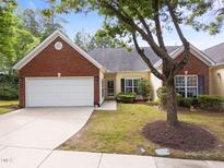 Charming home with a brick and siding exterior, well-manicured lawn, and a two-car garage at 2536 Bent Green St, Raleigh, NC 27614