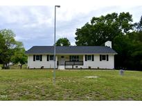 Charming single-story home with white brick, black shutters, and a well-manicured lawn at 3141 Wagoner Ln # 09, Graham, NC 27253