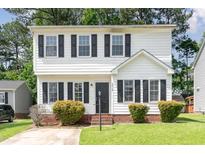 Charming two-story home with white siding, black shutters, and a well-maintained front yard and entryway at 3713 Phillips W Way, Durham, NC 27713