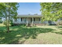 Charming single-story home with a welcoming front porch and well-maintained lawn at 3714 Mt Zion Church Rd, Mebane, NC 27302