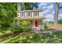 Charming two-story home featuring a bright red front door and covered porch at 40 Crepe Myrtle Ct, Angier, NC 27501