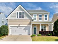 Charming two-story home featuring a two-car garage and manicured lawn at 4109 Massey Preserve Trl, Raleigh, NC 27616