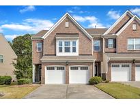 Charming brick townhome with a two-car garage and well-maintained landscaping at 416 Durants Neck Ln, Morrisville, NC 27560