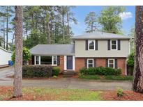 Charming two-story home featuring a brick facade, grey siding, and well-maintained landscaping at 509 E Millbrook Rd, Raleigh, NC 27609