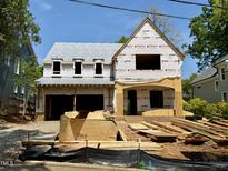 New home construction with covered porch awaiting finishing touches, showcasing its potential at 521 Peebles St, Raleigh, NC 27608