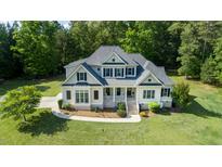 Beautiful two-story home featuring a lush lawn and charming front porch with inviting curb appeal at 639 Cedar Grove Rd, Pittsboro, NC 27312