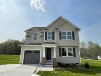 Beautiful two-story home featuring a 1-car garage and neutral-colored siding in a well-manicured yard at 94 Starry Sky Dr, Benson, NC 27504