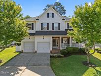 Charming two-story home with a manicured lawn, two-car garage, and inviting front porch at 1028 Bellenden Dr, Durham, NC 27713