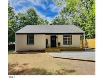 Charming single-story home with a welcoming front porch and freshly painted exterior, nestled in a lush, green surrounding at 116 Lumpkin St, Raleigh, NC 27610