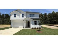 Charming two-story home with white siding, a well-manicured lawn, and an attached garage at 147 Gobbler Dr, Smithfield, NC 27577