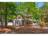 Charming two-story home with mature trees and a well-manicured lawn at 1816 Albacore Ln, Raleigh, NC 27612