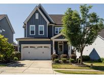 Charming two-story home featuring a two-car garage, landscaped front yard, and covered front porch at 1941 Bright Kannon Way, Wendell, NC 27591