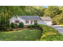 Charming single Gathering home featuring a manicured lawn and a 2-car attached garage at 205 Smiths Creek Dr, Clayton, NC 27520