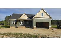 Charming home with gray siding, black shutters, and an unfinished front yard with attached garage at 25 Sanders Farm Dr, Smithfield, NC 27577