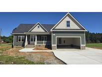 Charming home featuring a two-car garage, covered porch and craftsman style architecture at 25 Sanders Farm Dr, Smithfield, NC 27577