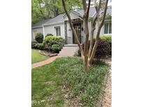 Charming home featuring a landscaped front yard with vibrant greenery and a quaint, inviting entryway at 2823 Fowler Ave, Raleigh, NC 27607
