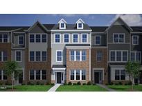 Charming new construction townhome with brick facade, gray siding, and meticulously maintained front yard at 339 Chesapeake Cmns St # 108, Garner, NC 27529