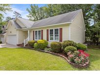 Charming single-story home with manicured lawn and colorful flowerbed at 4705 Forest Highland Dr, Raleigh, NC 27604