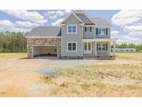 Charming two-story home features a welcoming entrance, attached two car garage, and classic architectural details at 48 Sanders Farm Dr, Smithfield, NC 27577