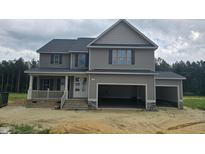 New construction two-story home featuring attached two-car garage, gray siding, and inviting front porch at 66 Sanders Farm Dr, Smithfield, NC 27577
