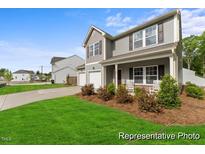 Charming two-story home with well-manicured lawn and inviting front porch, a perfect blend of comfort and style at 69 Curling Creek Dr # I286, Clayton, NC 27527