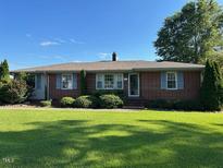 Charming one story home with brick exterior and well-manicured lawn at 8019 W Tarboro Rd, Rocky Mount, NC 27803