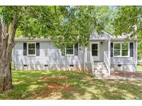 Charming single-story home featuring a well-maintained lawn and inviting front porch at 81 Honeysuckle Dr, Pittsboro, NC 27312