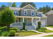 Inviting two-story home with a charming front porch, landscaped yard, and a gray-shingled exterior at 102 Kipling Dr, Oxford, NC 27565