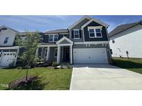 Charming home featuring gray siding, a two-car garage, and a well-manicured front lawn at 1033 Bostonian Dr, Knightdale, NC 27545