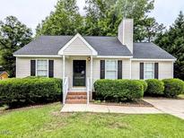 Charming home with a well-manicured lawn and neatly trimmed hedges adding to its curb appeal at 106 Grange Dr, Wendell, NC 27591