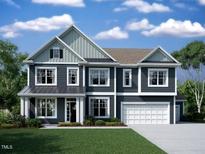 Charming two-story home with gray siding, white trim, a manicured lawn, and a two-car garage at 1313 Sparkling Lake Dr # 39, Apex, NC 27523