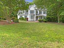 Charming two-story home with a manicured lawn and mature trees enhancing curb appeal at 150 Remington Ct, Youngsville, NC 27596