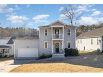 Charming two-story home featuring a welcoming porch and well-maintained yard in a desirable neighborhood at 187 Ashley Woods Ct, Clayton, NC 27527
