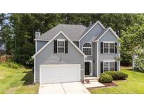 Charming two-story home with gray siding, black shutters, and a well-manicured lawn at 204 Trevor Ridge Dr, Holly Springs, NC 27540