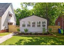 Charming exterior featuring a manicured lawn and neutral-colored siding with lovely curb appeal at 205 S Pettigrew St, Raleigh, NC 27610