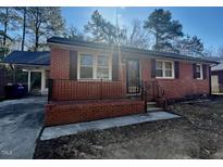 Charming brick home with a cozy front porch and covered carport at 2131 Dandridge Dr, Raleigh, NC 27610