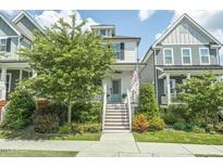 Charming two-story home with white siding, front stairs, and inviting curb appeal at 277 Douglas Falls Dr, Wendell, NC 27591