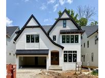 Striking new construction home featuring white brick, black trim, and a modern architectural design at 3008 Eden Harbor Ct, Raleigh, NC 27613