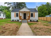 Charming home featuring a walkway leading to the front door and neat landscaping at 306 Coleman St, Oxford, NC 27565
