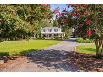 Charming two-story home with a front porch and mature trees at 3123 Brassfield Rd, Creedmoor, NC 27522