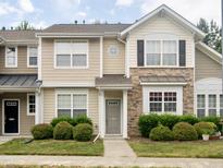 Charming townhome featuring stone accents, neutral siding, and inviting front entrance at 358 Red Elm Dr, Durham, NC 27713