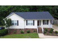 Charming single story home with bright siding, neat landscaping, and a welcoming front porch at 400 Southerby Dr, Garner, NC 27529
